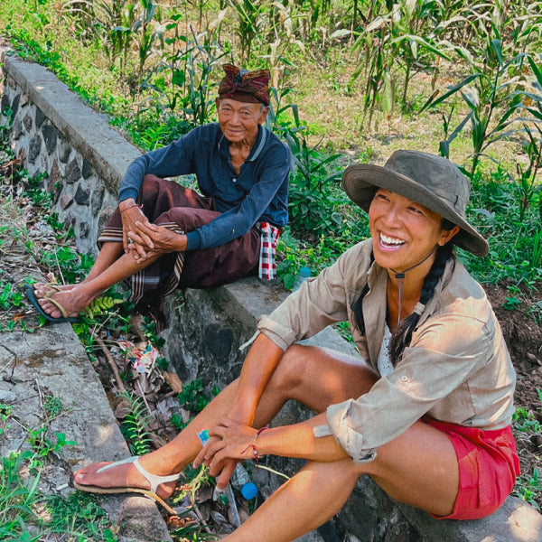 Jenny with Pak Nyoman Sudibia on the edges of his corn fields. Bali 2023.
