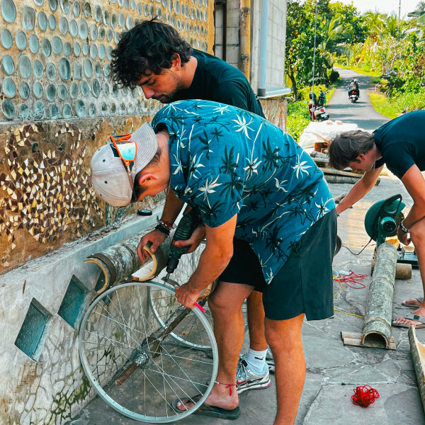 Volunteers building a mini hydro-wheel using scrap materials to power a local village in Tabanan, Bali. Summer 2025.