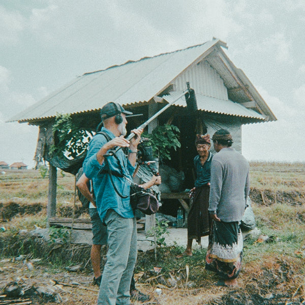 Behind the scenes production for Overbooked: film crew interviewing local rice farmer on the impacts of climate and over-tourism.